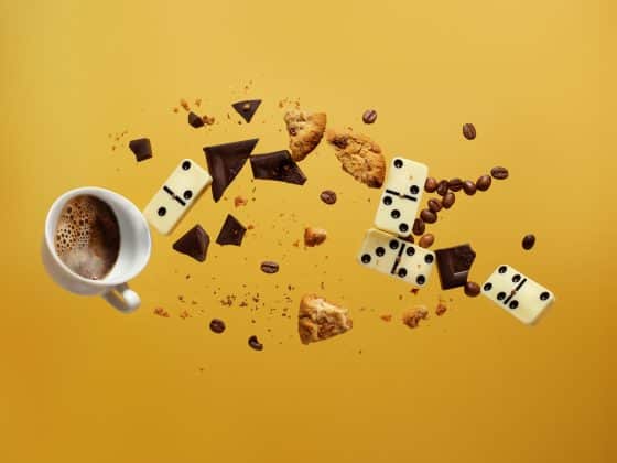 dominos and coffee falling with a yellow background