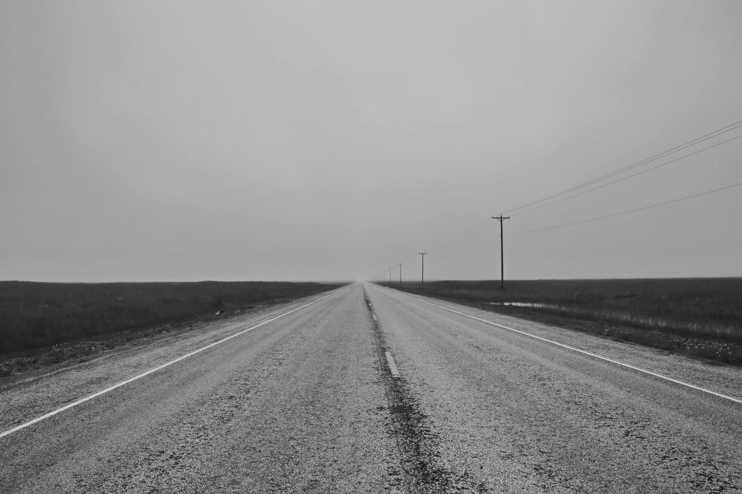 Black and white image of a lonely flat road - establishing the customer experience for business