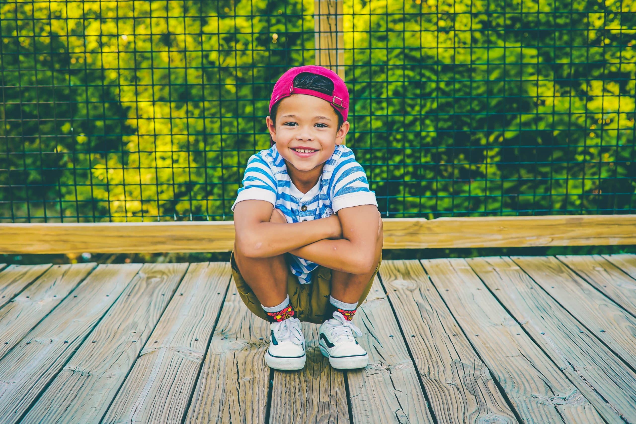 boy on a wooden porch near the railing