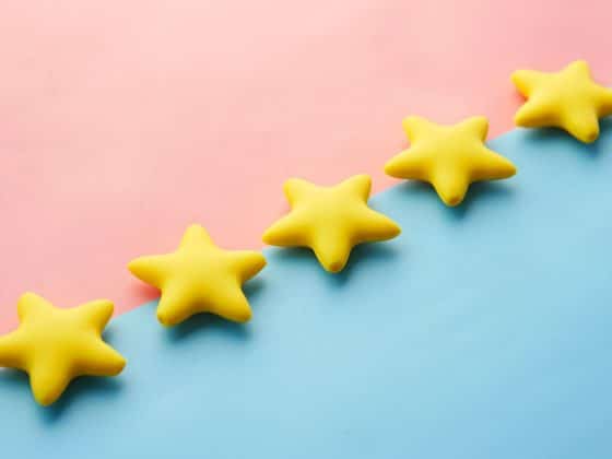5 yellow stars on a split pink and blue background.
