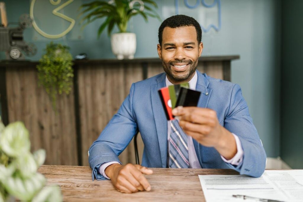 Man in a suit holding credit cards